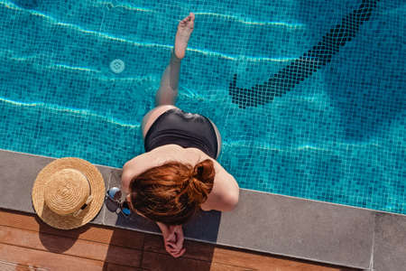 Young woman chilling in the the swimming poolの写真素材