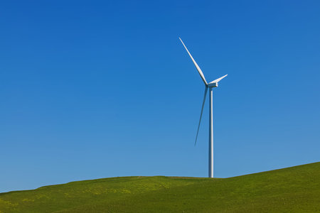 Electrical wind power mill over the blue sky. Alternative energy source. Ecological concept