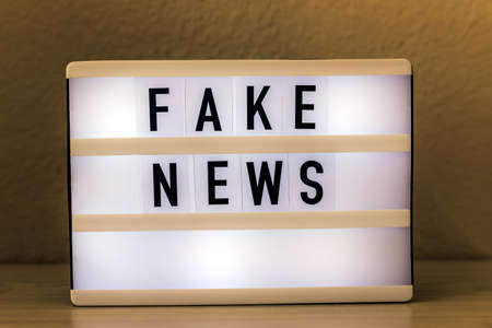 Light box with text Fake News. Journalism, propaganda, social media conceptの写真素材