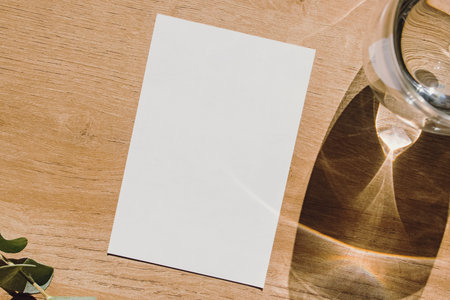 Minimalist letter format paper template, card mock-up on wooden table, top view.