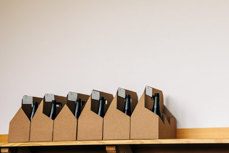 Cardboard boxes with bottles of wine standing on the shelves in the wine store