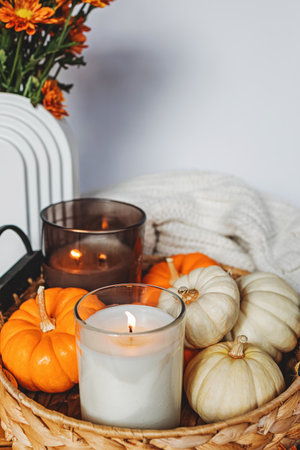 Cozy fall still life composition with decorative pumpkins and candles. Autumn home decor.の写真素材