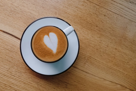 Cappuccino in a white mug, with heart on the top. Overhead view.の写真素材