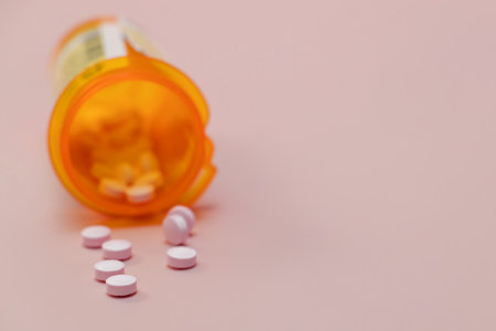 Pills in plastic orange bottle close-up, prescribed medication, painkillers, antidepressant. Selective focus.の写真素材
