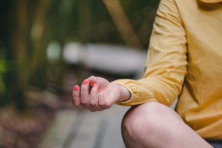 Meditation in the park, close-up of woman's hand, lotus poseの写真素材