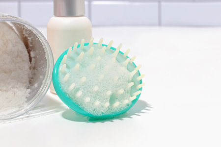 Hair brush for scalp massage and cleansing with shampoo foam close-upの写真素材