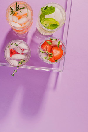 Summer refreshing drinks in a plastic tray on the purple background, top viewの写真素材