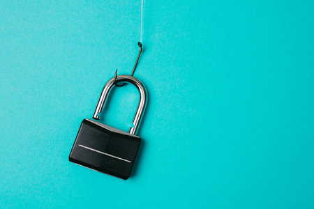Lock hanging on the fishing hook. Cyber security, phishing, password leak concept.の写真素材