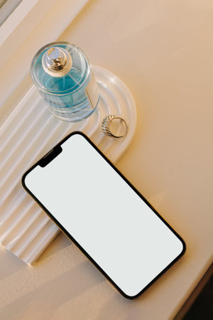 Still life composition with smartphone, perfume bottle and jewelry ring. Phone mock-up, natural lightの写真素材