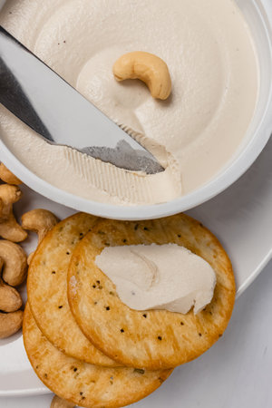 Cashew cream cheese with nuts and crackers, vegan dairy alternative close-upの写真素材