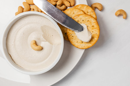 Cashew cream cheese with nuts and crackers, vegan dairy alternative close-upの写真素材