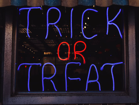 Glowing neon sign with text Trick or treat, Halloween conceptの写真素材