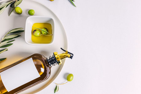 Olive oil in elegant bottle and olives, top viewの写真素材