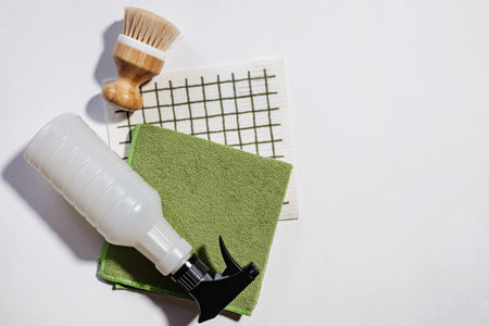 Cleaning brush, cloth and spray on white background, spring cleaning