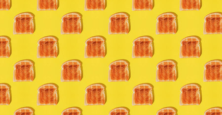 Creative food background, pattern with a slices of toasted bread on yellow