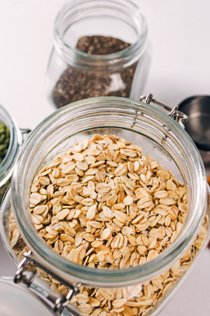 Close-up view of a glass jar full of rolled oats, healthy nutritionの写真素材