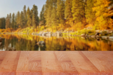 Empty display table with blurred fall landscape on the background, product demonstration templateの写真素材