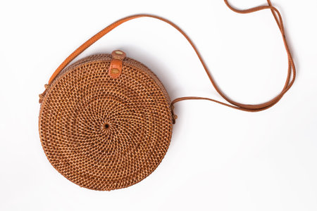 Stylish round straw bag isolated on the white background, top viewの写真素材