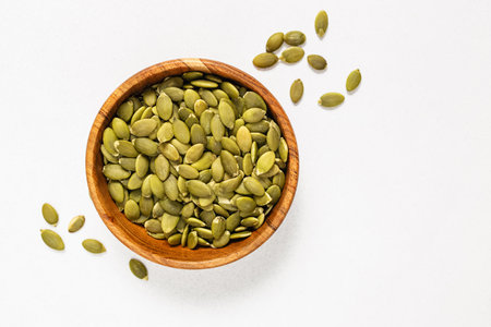 Pumpkin seeds in a wooden bowl, view from the topの写真素材