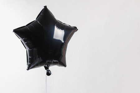 Star shaped balloon over the white wallの写真素材