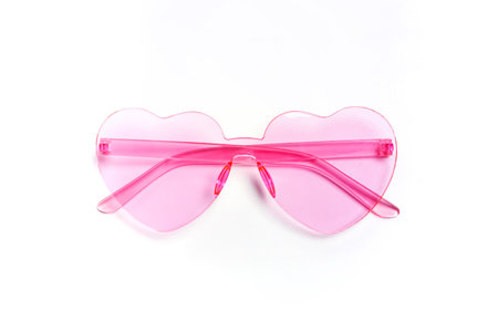 Cute heart-shaped pink sunglasses on a white backgroundの写真素材