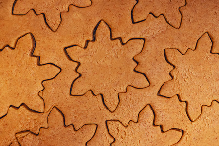 Close-up of cookie dough cut out in snowflake shapes, Christmas bakingの写真素材