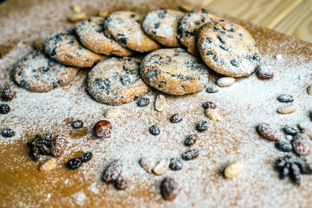 cookies with chocolate and nuts with wooden background powdered sugar and coffeeの写真素材
