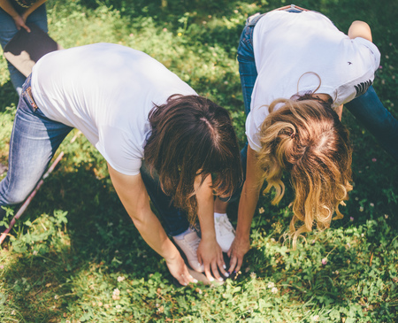 teambuilding exercises with people holding hands and legsの写真素材