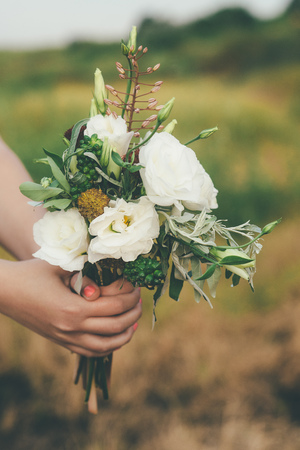 wedding peonies white in girl hands in suumer near the seaの写真素材
