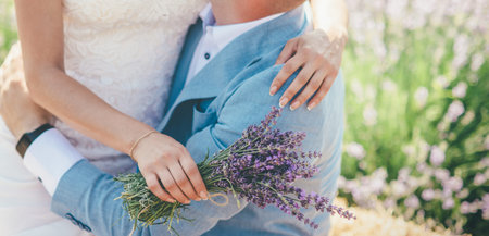 loving couple huggs on the lavender field in white wedding dress