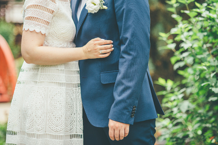 Beautiful wedding couple in park. They kiss and hug each otherの写真素材
