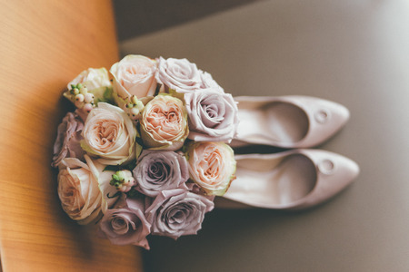 Bridal dusty pink high heels with diverse rose bouquetの写真素材