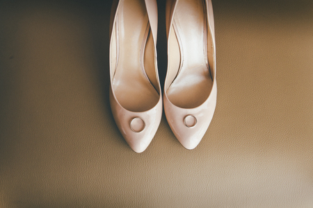 Beautiful pink heels for wedding laying on the chair, macro photoの写真素材