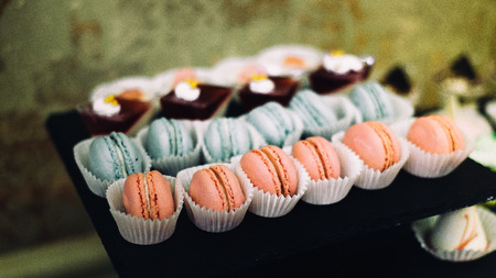 Plentiness of delicious french macaroons and some other desserts as a small snacks for celebrationの写真素材