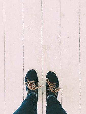 Stylish dark keds and white wooden floor, minimalistic legs closeupの写真素材