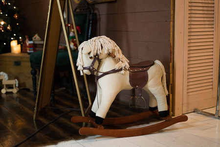 Rocking horse with christmas gift in the roomの写真素材
