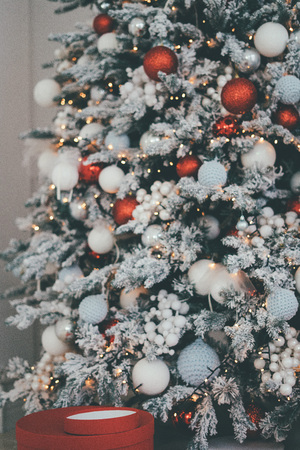 Beautiful Christmas tree decorated with matching warmly colored toys and lightsの写真素材