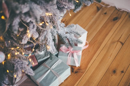 Abundance of the gifts under the athmospheric Christmas treeの写真素材