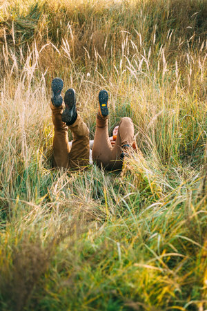 loving couple is falling into the grass in the field sunshine autumn