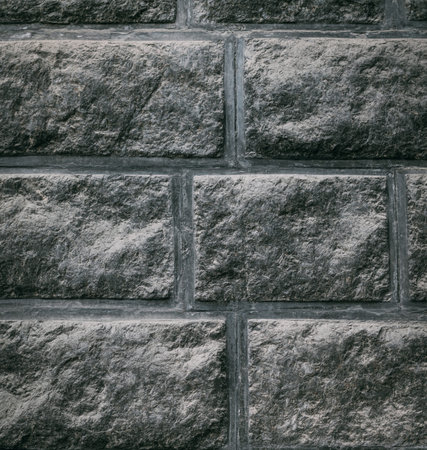 Gray brick wall texture background close-up.