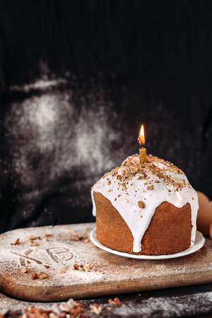 Easter dessert decorated with white icing on a wooden board.