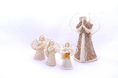 White Christmas straw angels ornament isolated on white background.の写真素材