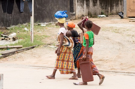 In abidjan, there are women who walk each day to fetch dirty linen washing what they have in hand is their work tools.のeditorial素材