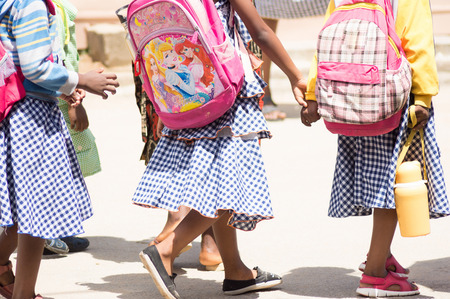 schoolgirls were caught hands to get to house at noon .のeditorial素材