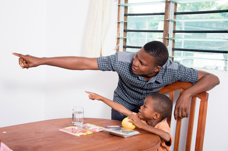 Dad showing something to His child.の写真素材
