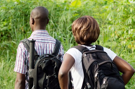 A couple of young hand ride in the bush with bags back.の写真素材