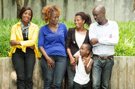 Gathered young people in the park against the wall, enjoying the nice weather.の写真素材