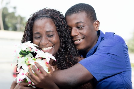 young woman is very happy recevoir this beautiful flower.の写真素材