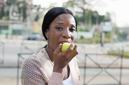 young woman is eating an apple Because It is nutritions.の写真素材