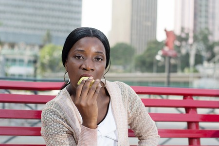 young woman is eating an apple Because it is nutritious.の写真素材